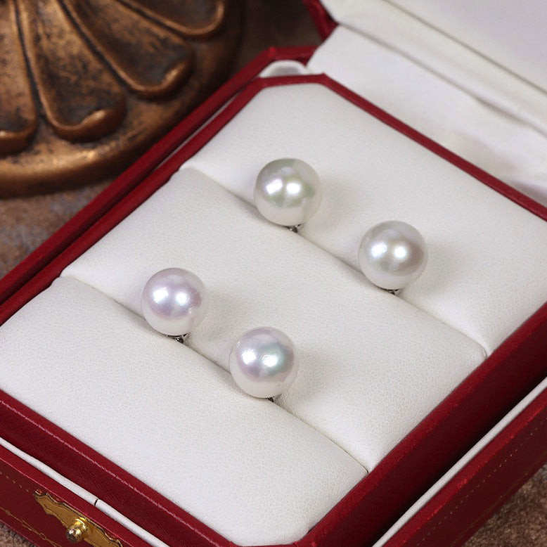 10-11mm Nearly Round Edison Pearl Earrings with varying lusters displayed under the light