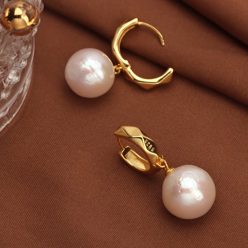Close-up detail of the metal earring post part of the 11-12mm Round Edison Pearl Drop Earrings.