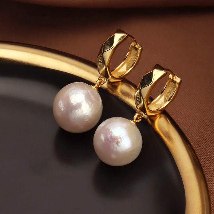 11-12mm Round Edison Pearl Drop Earrings displaying an enchanting luster under the light.