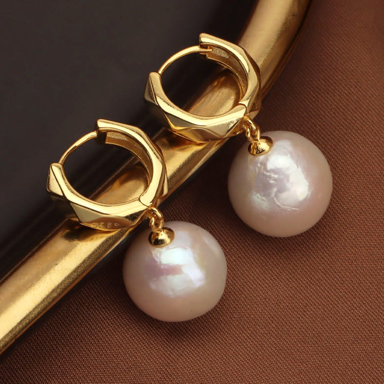 Detailed showcase and luster presentation of the 11-12mm Round Edison Pearl Drop Earrings.