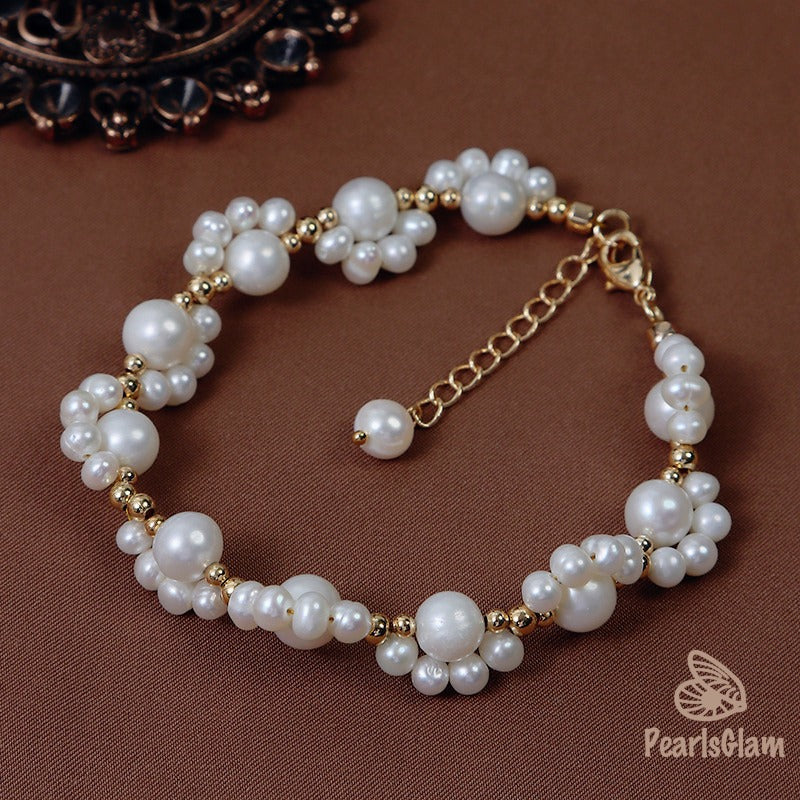 Pearl bracelet with gold accents on a brown background, branded 'PearlsGlam'.