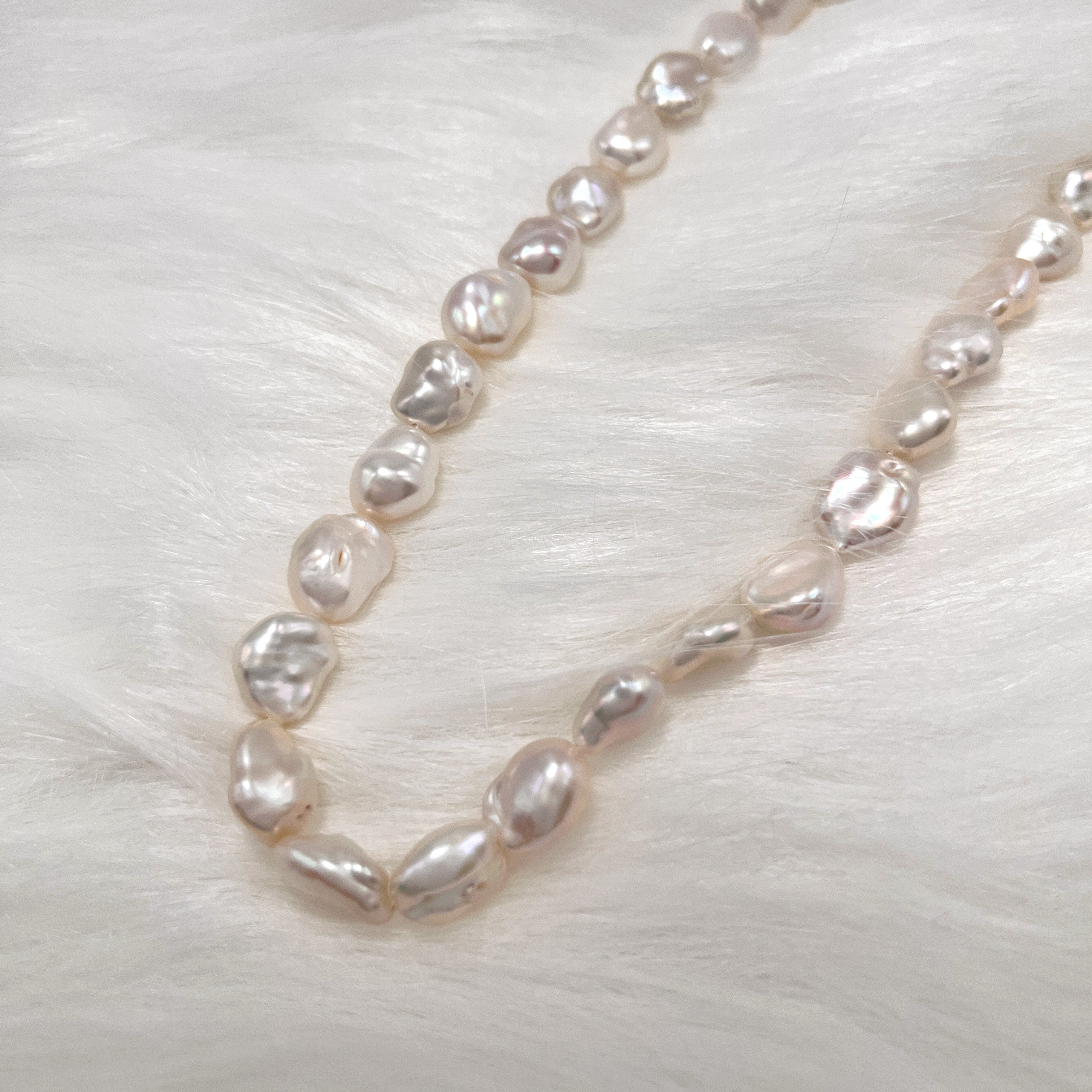Indoor lighting showcases the 10-11mm Freshwater Baroque Pearl Necklace
