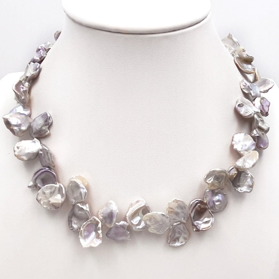 11-14mm petal-shaped Keshi pearl necklace displayed on a white mannequin stand.