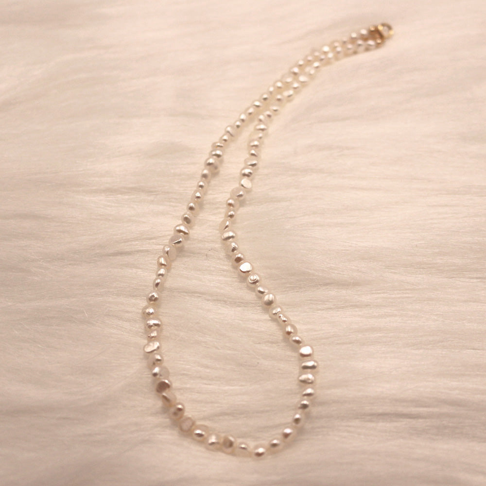 Detailed showcase and luster presentation of the 3-4mm Irregular Freshwater Pearl Necklace