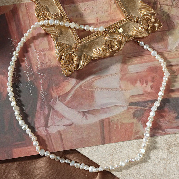 3-4mm Irregular Freshwater Pearl Necklace styled with a background to exude a classical elegance.