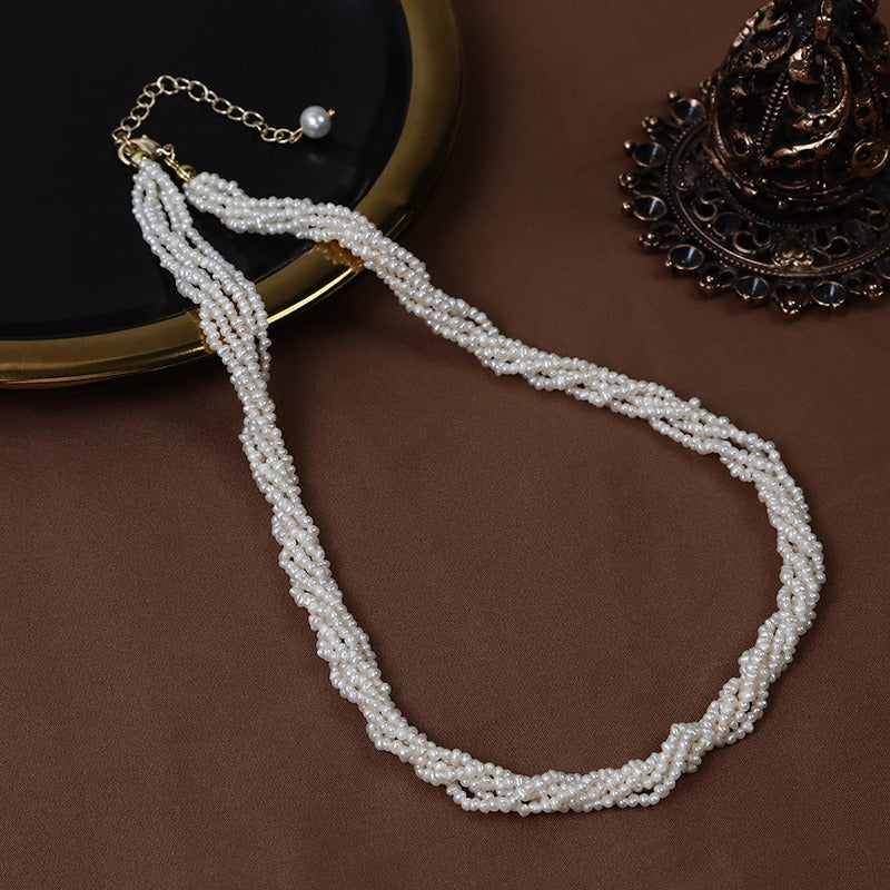 Baby Freshwater Pearls Twisted Chain Necklace displays a classic and elegant style.