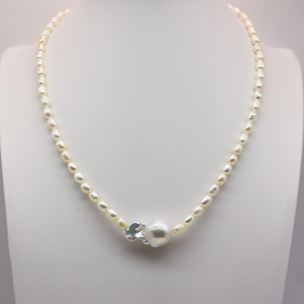 Baroque Pearl Pendant on an Oval Pearl Necklace displayed under cool-toned lighting.