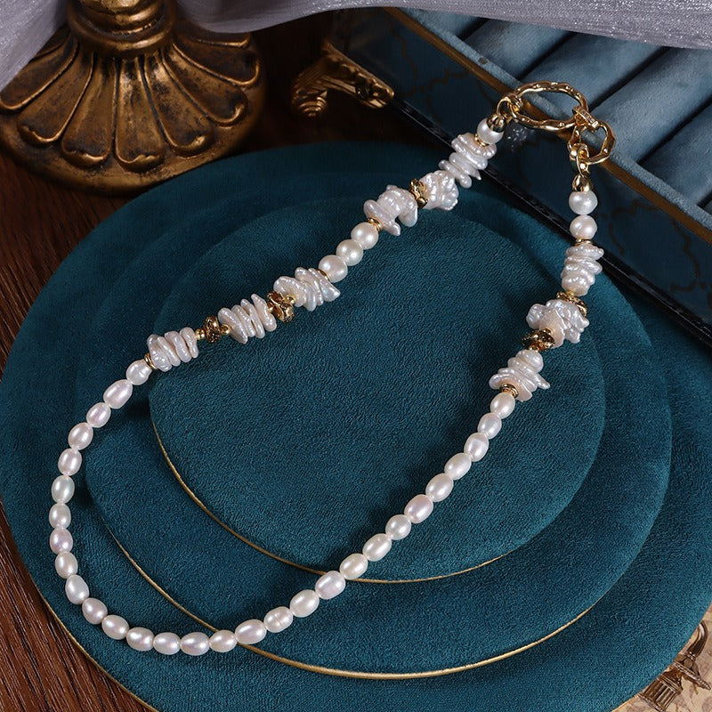 The Flat Keshi and Oval Pearl Strung Necklace offers a distinctive design, ideal for those seeking a one-of-a-kind fashion statement.