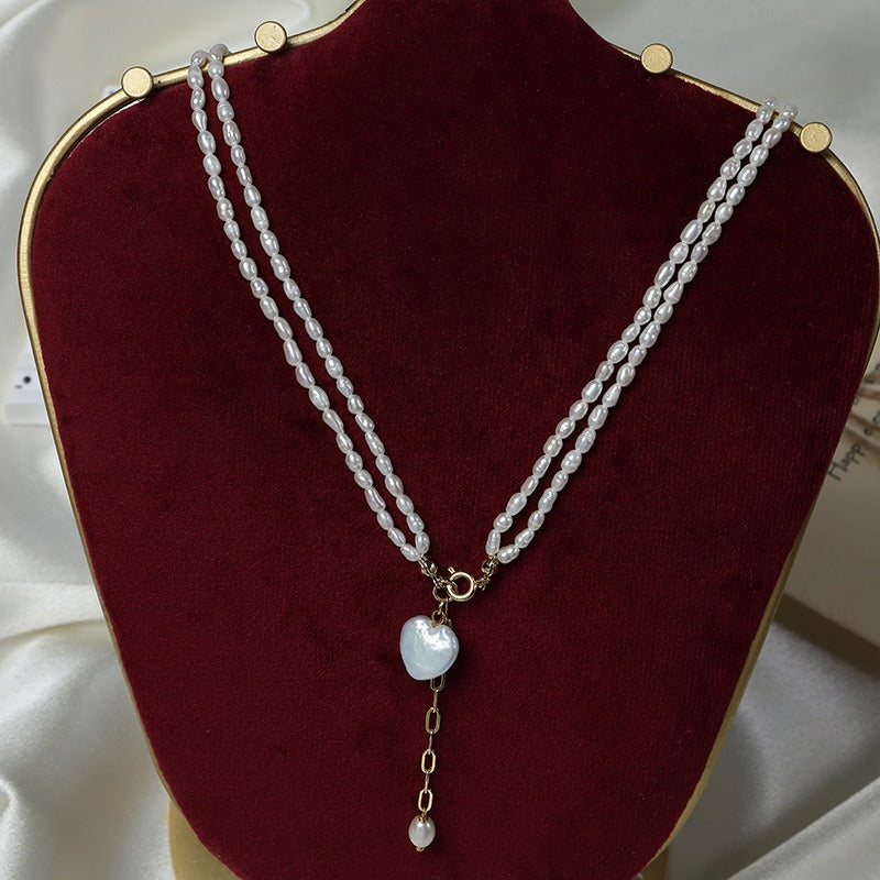 Heart Keshi Pearl Pendant with Rice Bead Pearl Necklace displayed on a Red model display stand