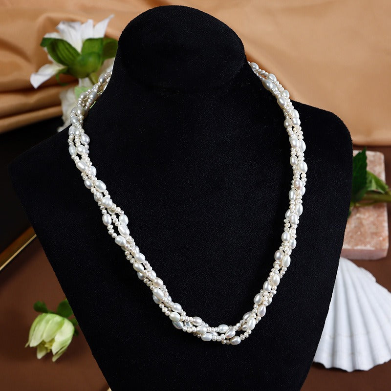 Oval Freshwater Pearls Twisted Chain Necklace displayed on a black velvet jewelry display stand.