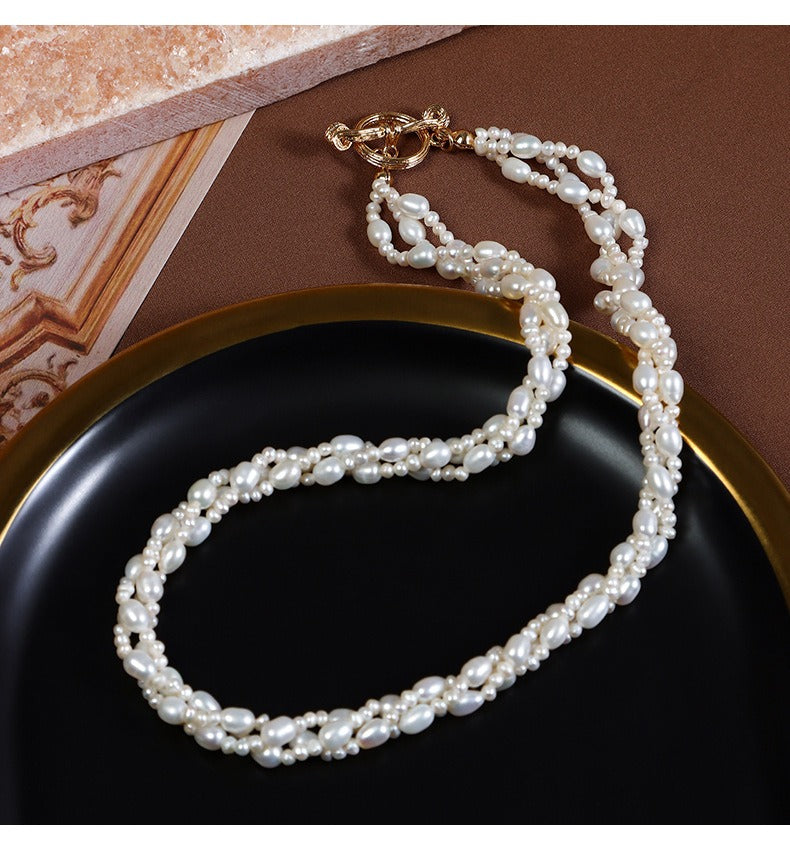 The pearl luster and intricate details of the Oval Freshwater Pearls Twisted Chain Necklace are on display.